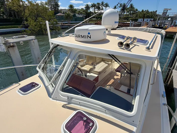 Moncri Yacht Photos Pics 2012 MJM 36z Downeast boat with Garmin equipment, docked in a scenic marina.