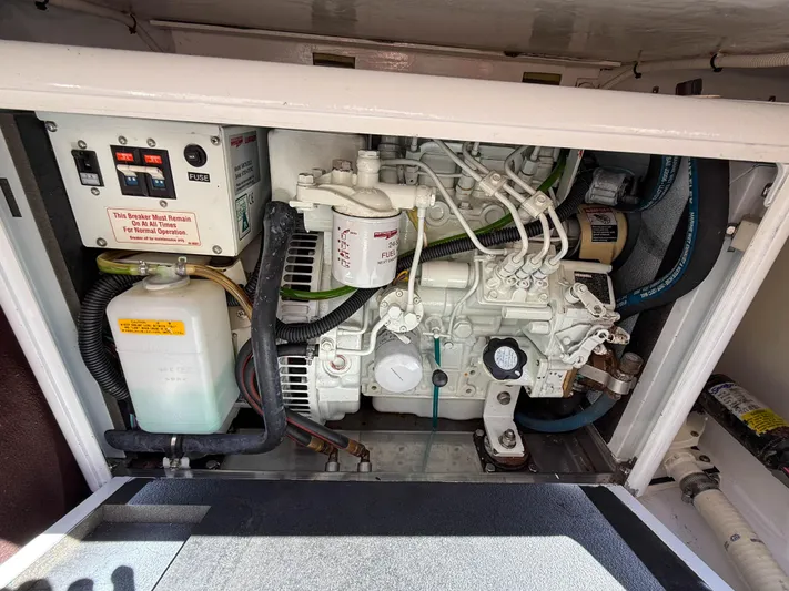 Moncri Yacht Photos Pics Engine compartment of a 2012 MJM 36z Downeast boat, showcasing mechanical components.