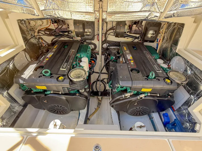Moncri Yacht Photos Pics Engine compartment of a 2012 MJM 36z Downeast boat, showcasing dual engines.