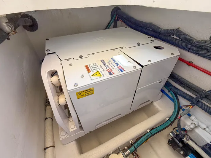 Moncri Yacht Photos Pics Engine compartment of 2012 MJM 36z Downeast boat, featuring mechanical components and wiring.