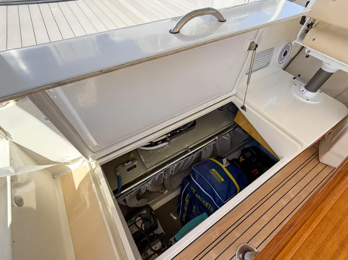 Moncri Yacht Photos Pics Storage compartment on 2012 MJM 36z Downeast boat, featuring life jackets and equipment.