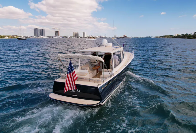 Moncri Yacht Photos Pics 2012 MJM 36z Downeast boat cruising on open water with American flag.