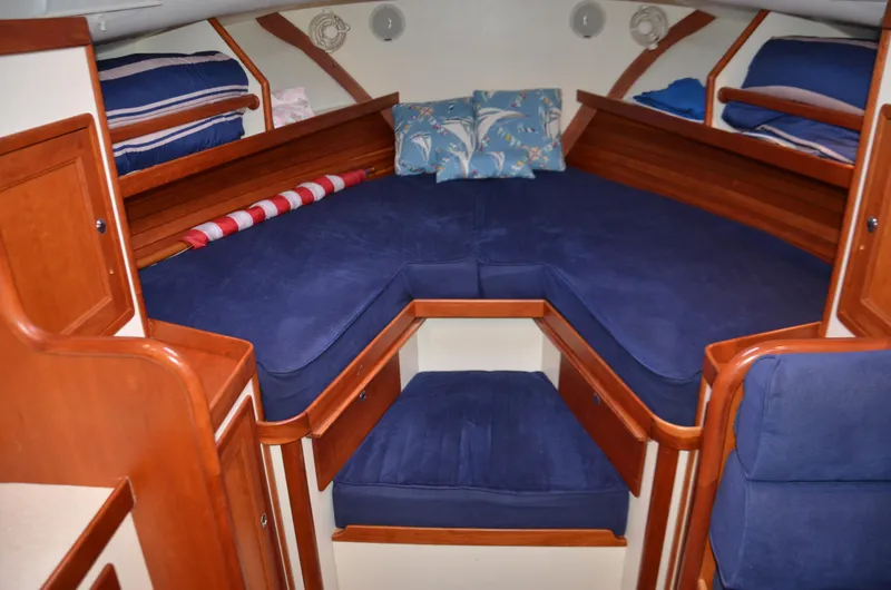 Patriot Yacht Photos Pics 2003 Little Harbor WhisperJet 38 cabin with blue cushions and wooden interior.