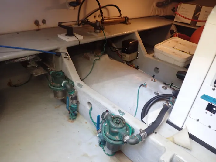 No Quarter Yacht Photos Pics Engine room of 2006 Mainship 34 Trawler with visible mechanical components.