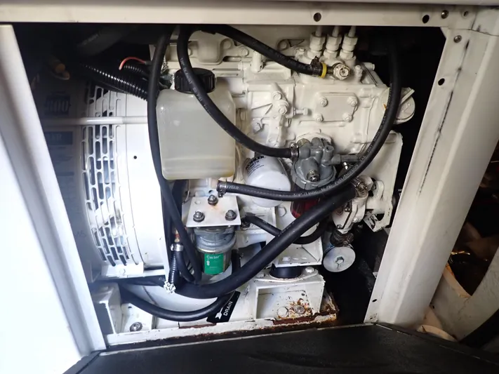 No Quarter Yacht Photos Pics Engine compartment of a 2006 Mainship 34 Trawler, showcasing mechanical components and wiring.