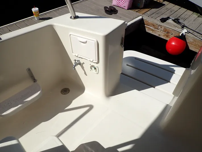 No Quarter Yacht Photos Pics 2006 Mainship 34 Trawler deck area with dock view and red buoy.