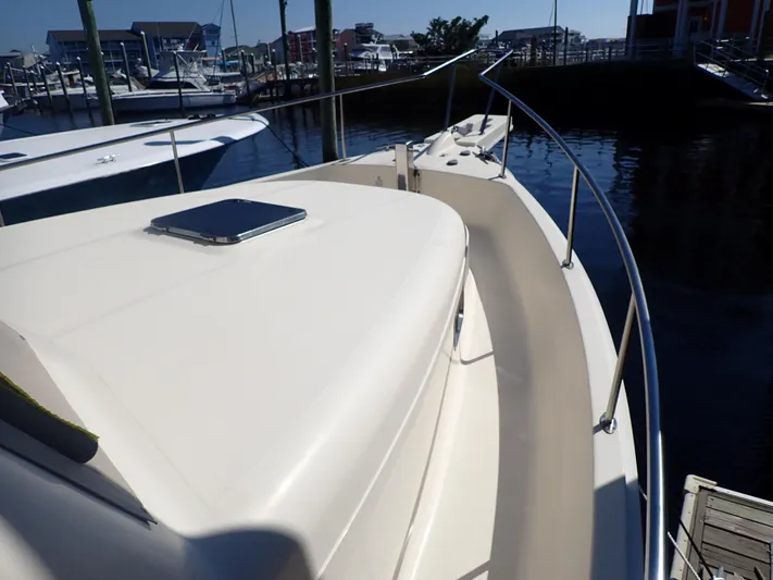 No Quarter Yacht Photos Pics 2006 Mainship 34 Trawler boat deck with railing, docked at marina.