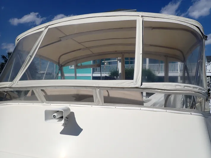 No Quarter Yacht Photos Pics 2006 Mainship 34 Trawler with enclosed flybridge under clear blue sky.