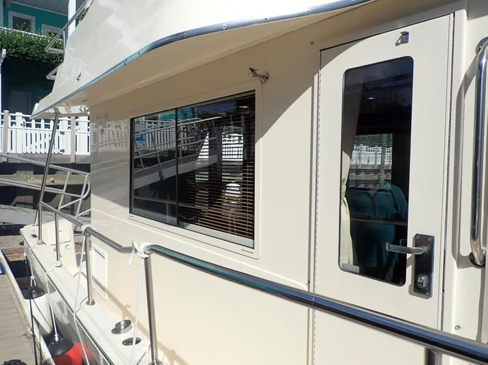 No Quarter Yacht Photos Pics 2006 Mainship 34 Trawler side view with window and door detail.