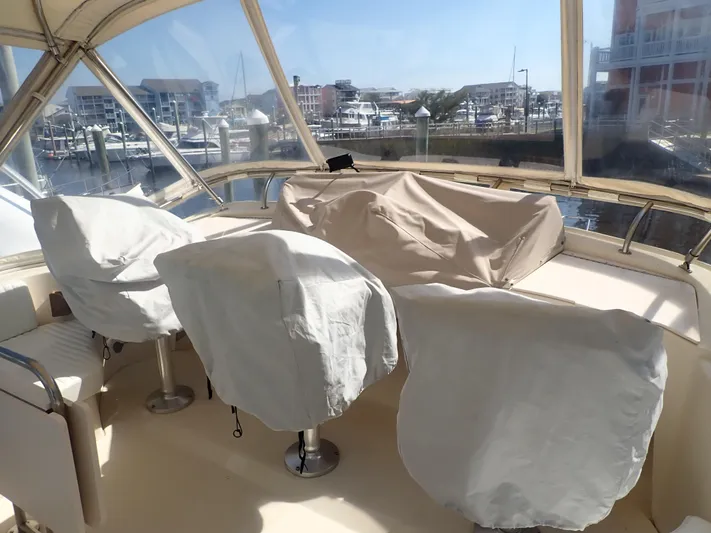 No Quarter Yacht Photos Pics 2006 Mainship 34 Trawler interior with covered seating, docked at a marina.