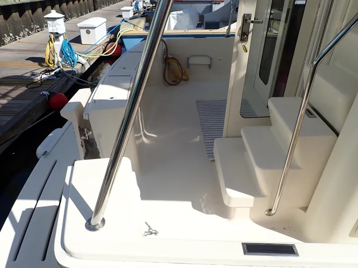 No Quarter Yacht Photos Pics 2006 Mainship 34 Trawler docked, showing deck and entry steps.