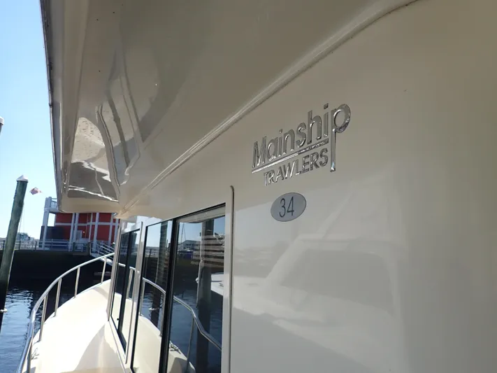 No Quarter Yacht Photos Pics 2006 Mainship 34 Trawler docked, showcasing sleek design and branding.