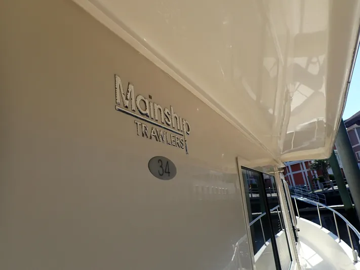 No Quarter Yacht Photos Pics 2006 Mainship 34 Trawler boat exterior with logo and model number.