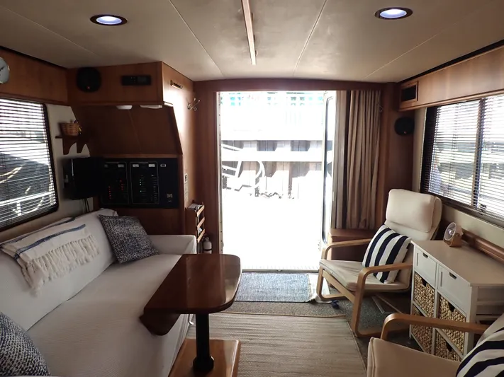 No Quarter Yacht Photos Pics Interior of 2006 Mainship 34 Trawler with cozy seating and wooden accents.