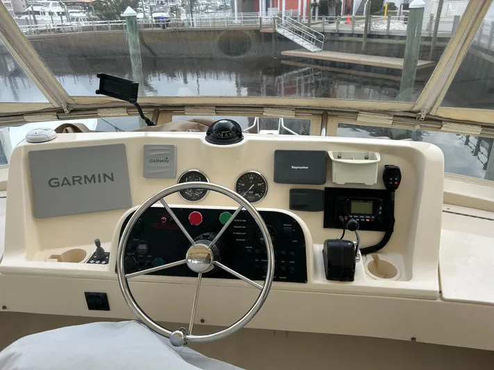 No Quarter Yacht Photos Pics Helm of 2006 Mainship 34 Trawler with Garmin navigation system and various controls.