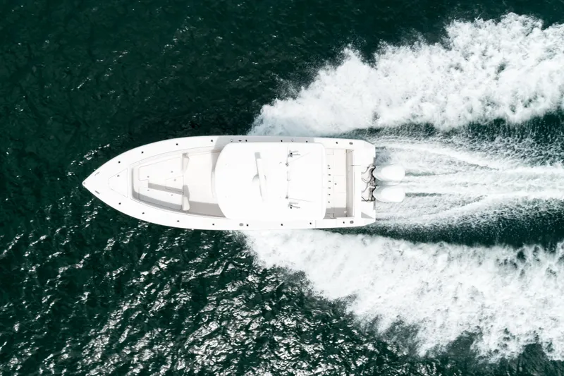  Yacht Photos Pics Aerial view of 2012 Jupiter 34 FS boat speeding on open water.