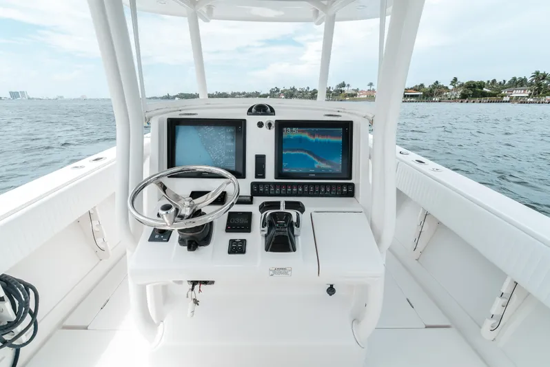  Yacht Photos Pics 2012 Jupiter 34 FS boat helm with dual screens and steering wheel on open water.