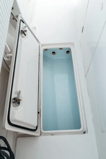  Yacht Photos Pics Open storage compartment on 2012 Jupiter 34 FS boat, featuring a white and blue interior.