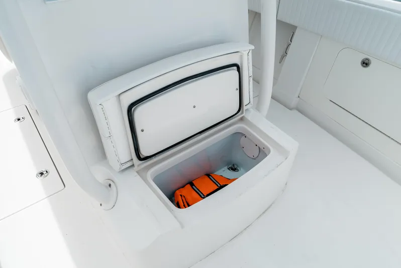  Yacht Photos Pics Open storage compartment on 2012 Jupiter 34 FS boat with orange life jacket inside.