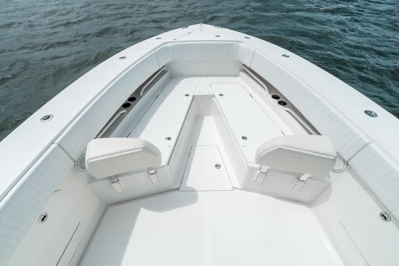  Yacht Photos Pics 2012 Jupiter 34 FS boat interior with white seating and storage, on calm water.