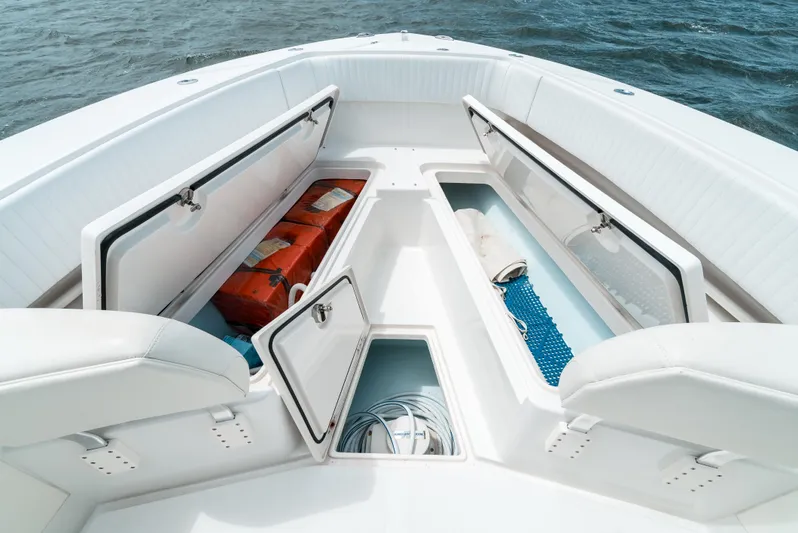  Yacht Photos Pics 2012 Jupiter 34 FS boat with open storage compartments on deck, floating on water.