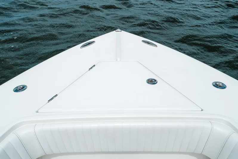  Yacht Photos Pics Bow of 2012 Jupiter 34 FS boat on water, showcasing sleek design and white finish.