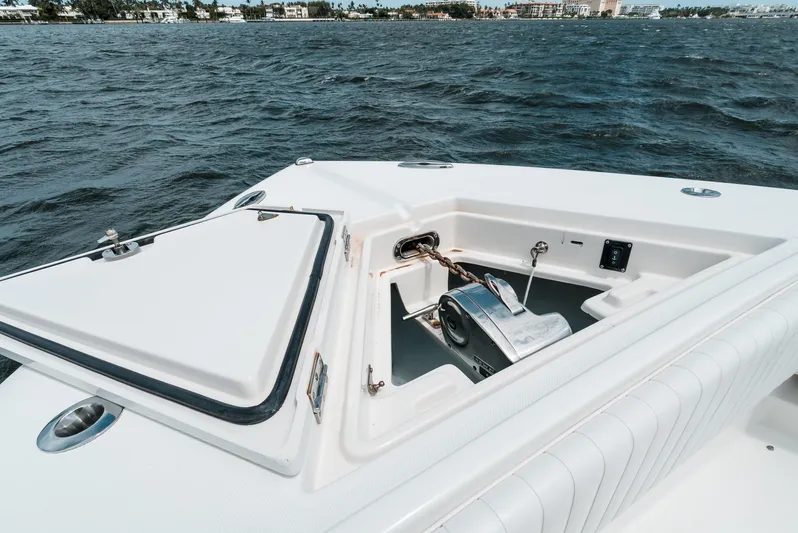  Yacht Photos Pics Bow of 2012 Jupiter 34 FS boat with anchor compartment, on water.