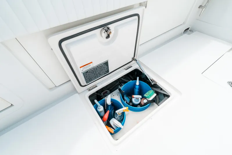  Yacht Photos Pics Open storage compartment on 2012 Jupiter 34 FS boat with cleaning supplies.