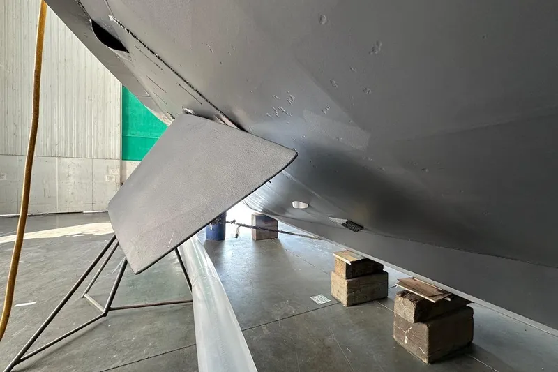 Andiamo Yacht Photos Pics Underside view of a 1991 Broward 102 yacht in a maintenance facility.