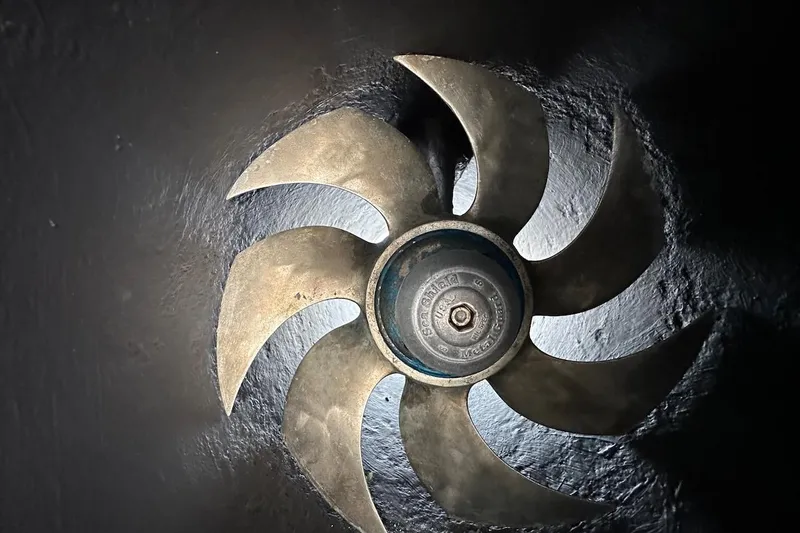 Andiamo Yacht Photos Pics Bronze propeller of a 1991 Broward 102 yacht, showcasing intricate blade design.