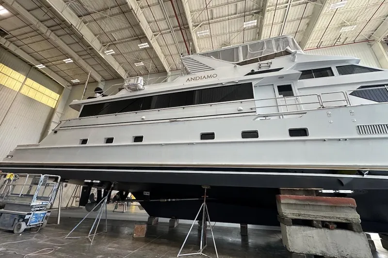 Andiamo Yacht Photos Pics Large 1991 Broward 102 yacht in a shipyard for maintenance.