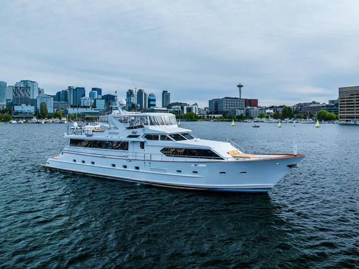 Andiamo Yacht Photos Pics Luxurious 1991 Broward 102 yacht cruising on a scenic urban waterfront.
