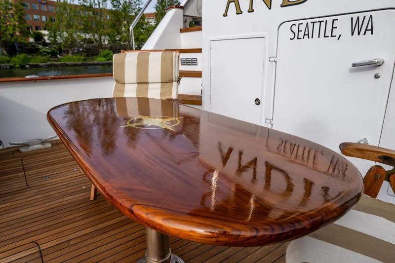 Andiamo Yacht Photos Pics Polished wooden table on 1991 Broward 102 yacht deck, Seattle, WA.