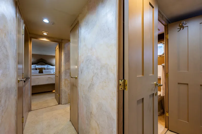 Andiamo Yacht Photos Pics Hallway in 1991 Broward 102 yacht with bedroom and bathroom doors.