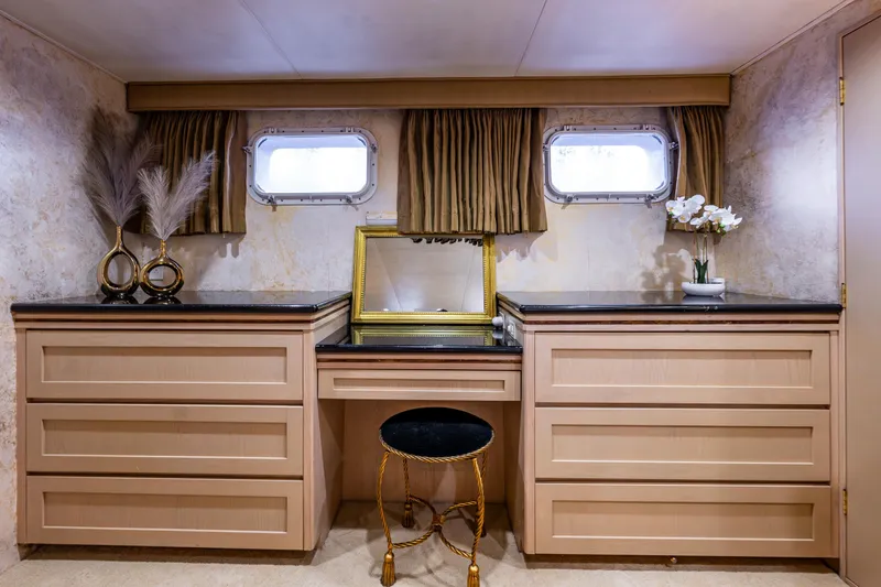 Andiamo Yacht Photos Pics Luxurious vanity area on a 1991 Broward 102 yacht with elegant decor and seating.