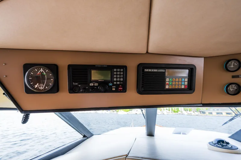 Andiamo Yacht Photos Pics Interior dashboard of a 1991 Broward 102 yacht with navigation instruments.