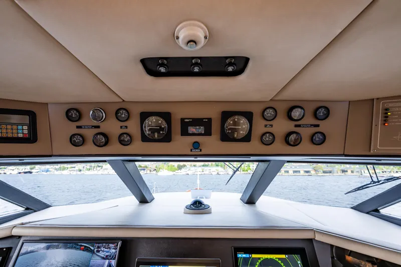 Andiamo Yacht Photos Pics Interior view of 1991 Broward 102 yacht cockpit with navigation instruments.