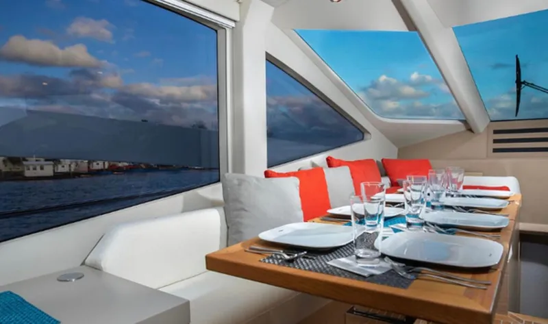  Yacht Photos Pics Luxurious dining area on 2019 Numarine 78 yacht with panoramic windows and elegant table setting.