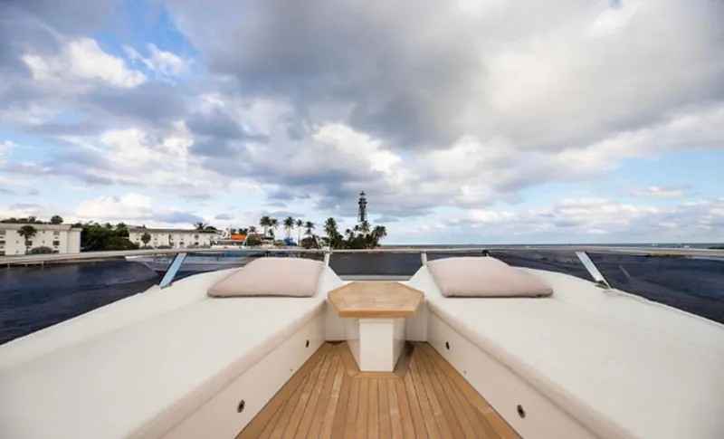  Yacht Photos Pics Luxurious 2019 Numarine 78 yacht deck with cushions, ocean view, and cloudy sky.