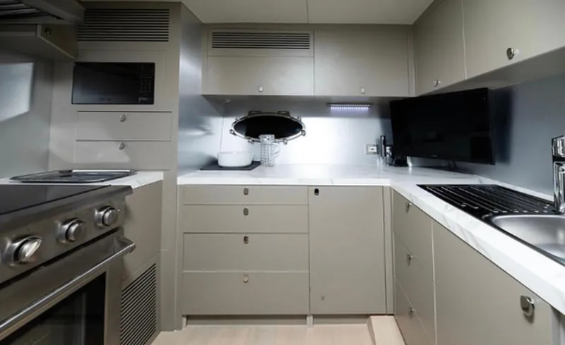 Yacht Photos Pics Modern kitchen interior on 2019 Numarine 78 yacht, featuring sleek cabinetry and stainless steel appliances.