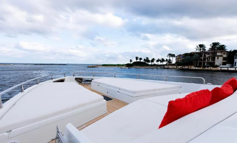  Yacht Photos Pics Luxurious 2019 Numarine 78 yacht deck with white seating and red cushions, overlooking serene waters.