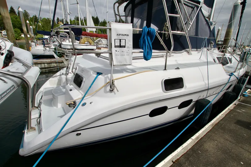  Yacht Photos Pics 2001 Hunter Passage 420 yacht docked at marina, featuring sleek design and blue ropes.