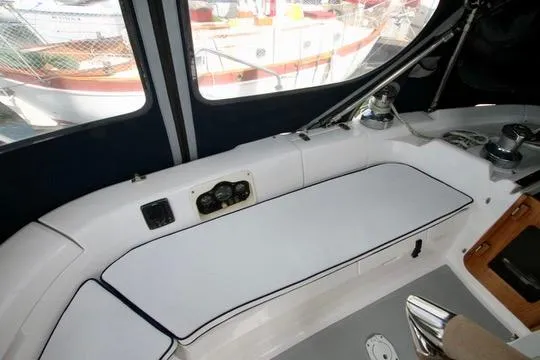  Yacht Photos Pics Interior view of a 2001 Hunter Passage 420 sailboat cockpit with seating and controls.