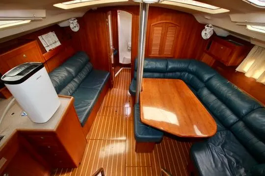  Yacht Photos Pics Interior of 2001 Hunter Passage 420 yacht with wooden furnishings and blue seating.