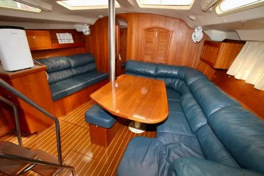  Yacht Photos Pics Interior of 2001 Hunter Passage 420 yacht with wooden furnishings and blue seating.
