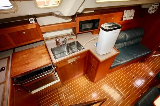  Yacht Photos Pics Interior of 2001 Hunter Passage 420 yacht with wooden cabinetry and modern amenities.