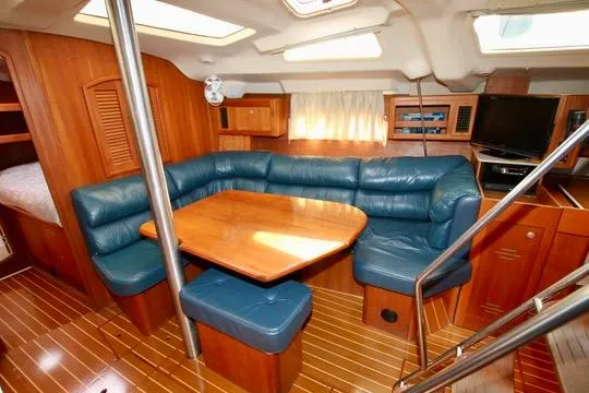  Yacht Photos Pics Interior of 2001 Hunter Passage 420 yacht with blue leather seating and wooden furnishings.
