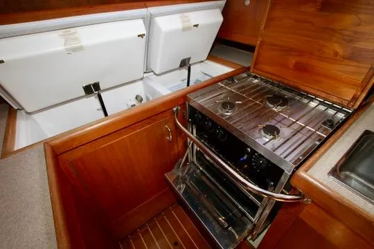  Yacht Photos Pics Galley kitchen in 2001 Hunter Passage 420 yacht with stove and storage compartments.