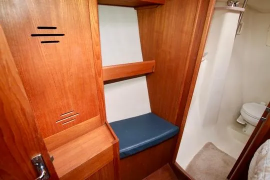  Yacht Photos Pics Interior of 2001 Hunter Passage 420 sailboat with wooden cabinetry and compact bathroom.