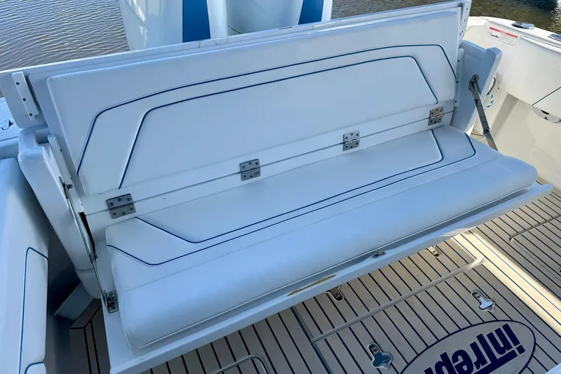  Yacht Photos Pics 2025 Intrepid 327 Cuddy boat with foldable white seating and teak deck.